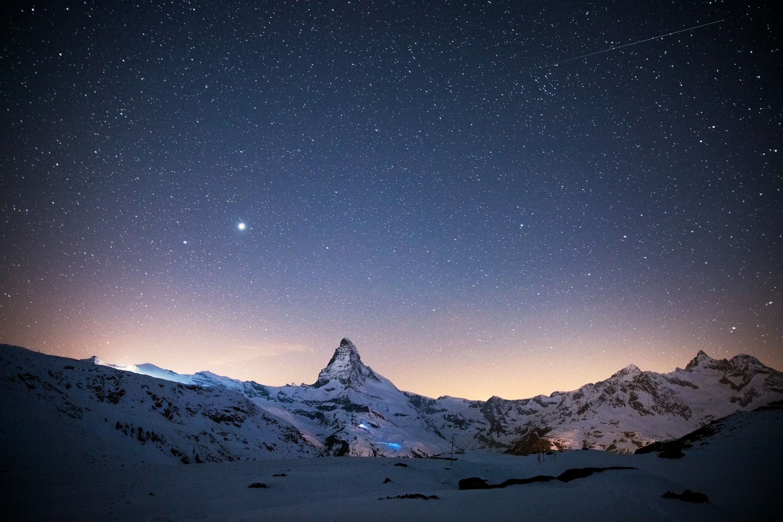 Scenic train travelling through snowy Swiss mountains