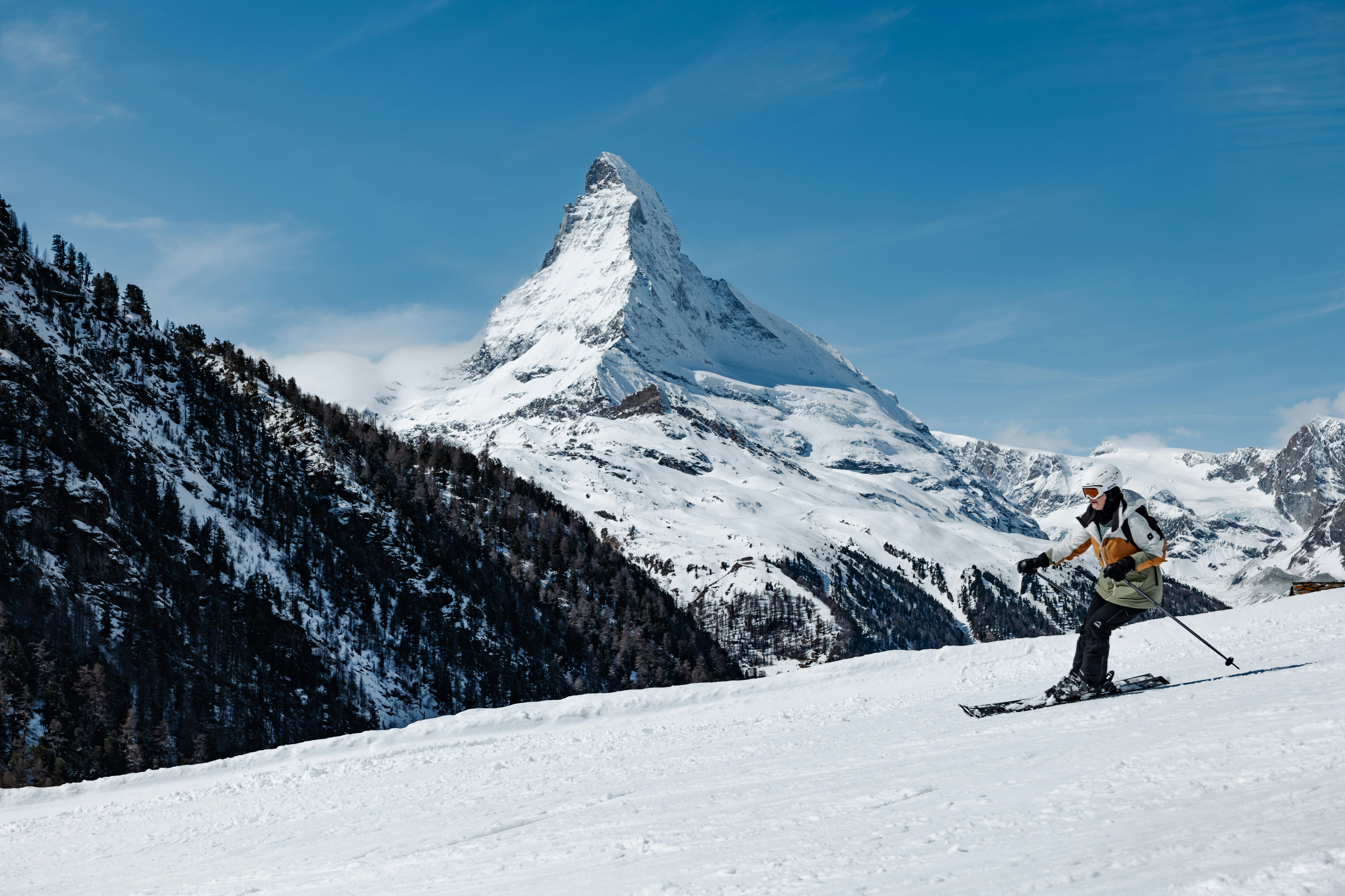 Skiers descending with the Matterhorn in the background